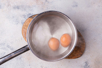 Put a pot of water on the stove and let it boil.

Add the eggs and boil for 6 minutes, then cool in cold water and peel. If you want a more cooked egg, boil a few minutes longer.
