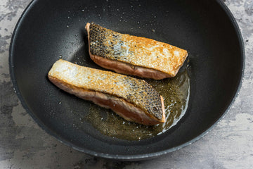 Pat the **fish **dry with paper towels. Season with **salt **and **pepper**. Heat a pan over medium heat, add a drizzle of oil, and cook the **fish **for **3–4 minutes** on each side.
