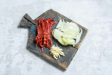 Peel and slice the onion, garlic and chorizo.
