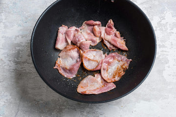 Brown the sliced **bacon **in a pan and set aside.
