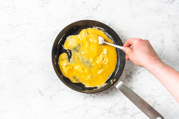 When the **vegetables** and **chicken** are cooked through, remove them from the pan.

Take a bowl and whisk the **eggs** with a fork. Put the pan back on the stove and add the **oil**. When the **oil** has heated, quickly pour the **eggs** into the pan and stir for 5-10 seconds - the **egg** should start to "foam" in the pan.
