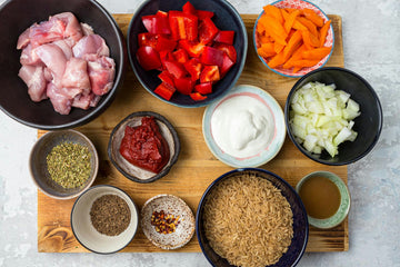 Cut the peeled **onion **and **carrot**, **chicken** and **bell pepper** into smaller cubes.
