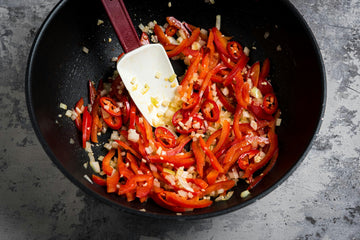 Heat the **oil **in a pan and brown the pre-chopped **veggies **until the **onion **becomes translucent.

