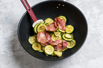 Add the sliced **potatoes **and **bacon **to the pan and heat once more.
